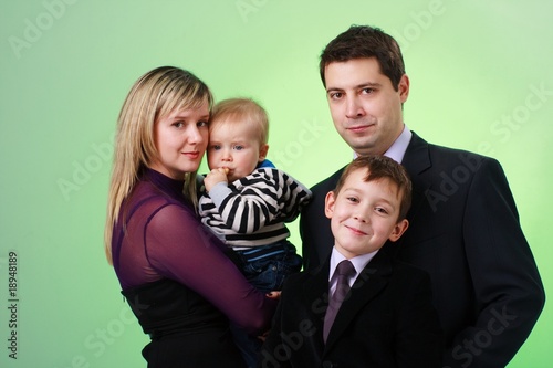 Fototapeta Naklejka Na Ścianę i Meble -  happy family on a green background