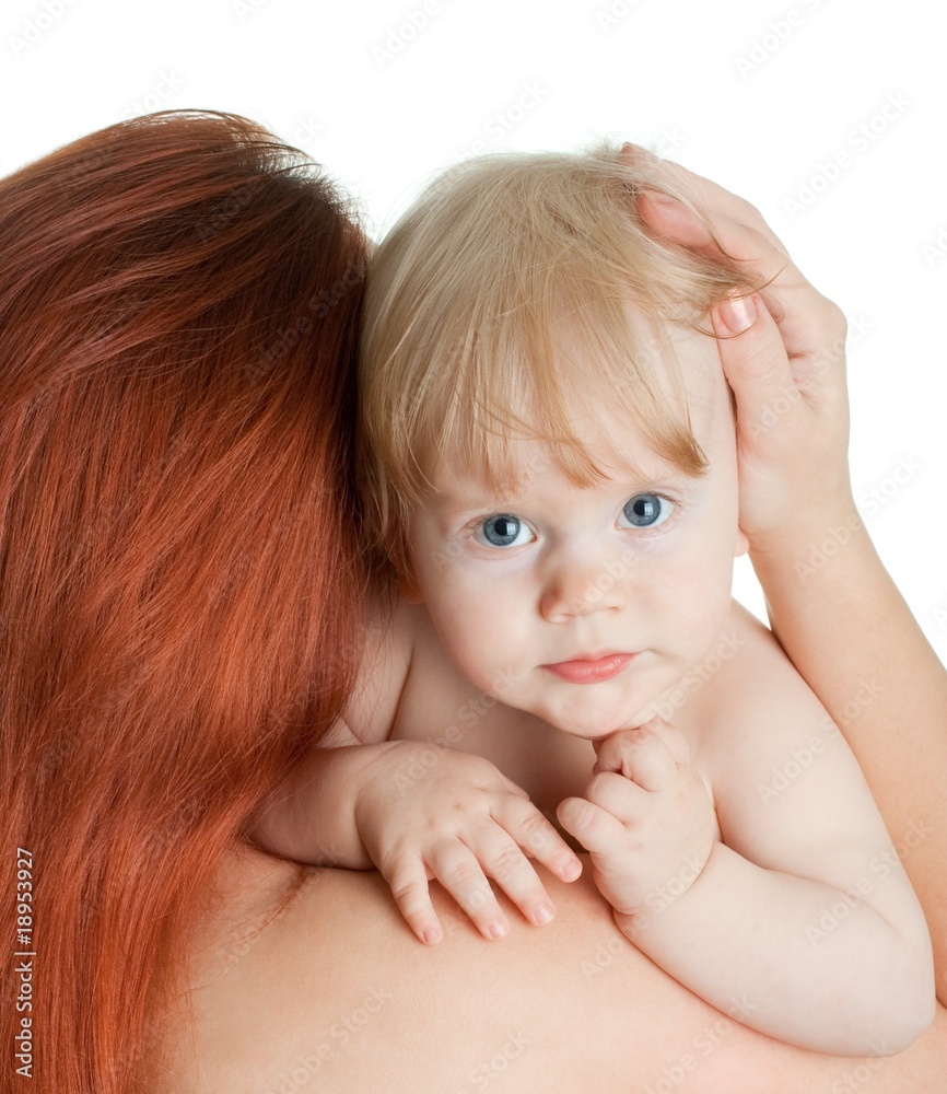 baby girl after bathing in the red-haired mother's hug baby girl after bathing in the red-haired mother's hug