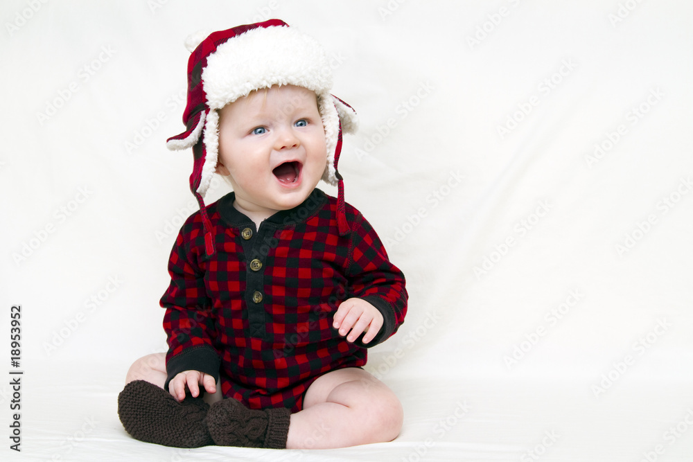 Christmas baby with red plaid shirt and furry wool hat Christmas baby with red plaid shirt and furry wool hat