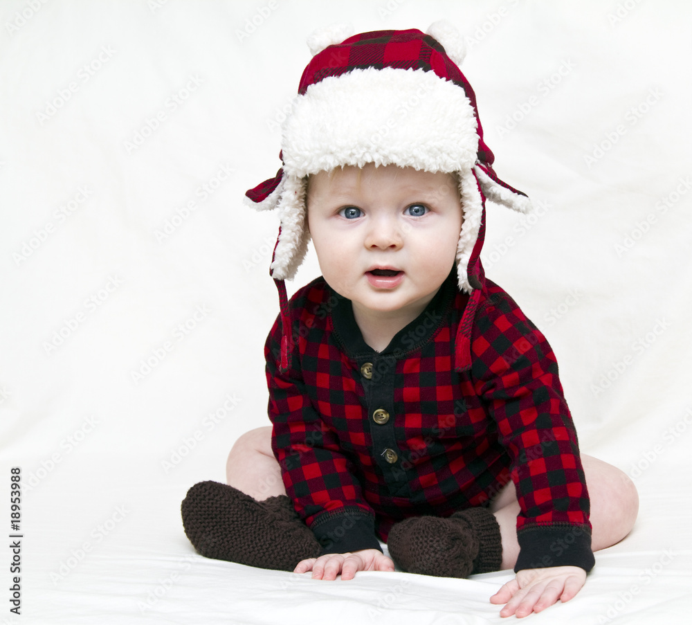 Christmas baby with red plaid shirt and furry wool hat Christmas baby with red plaid shirt and furry wool hat