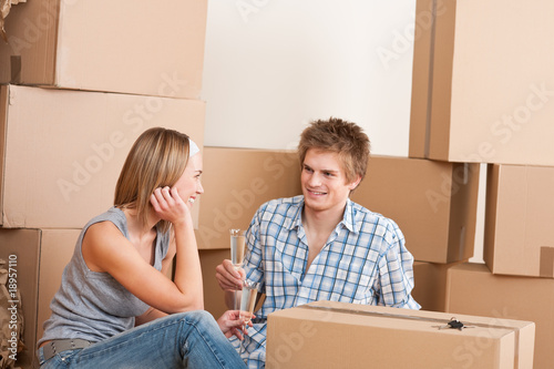 Moving house: Happy man and woman celebrating © CandyBox Images