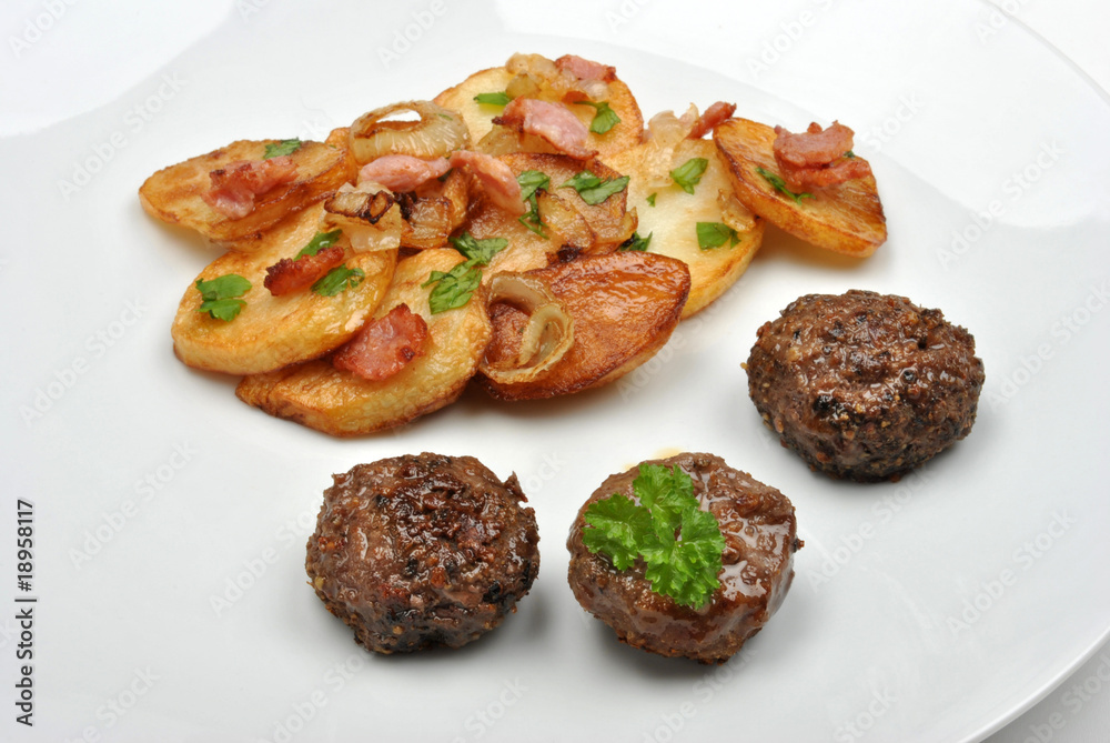 roasted potato with meat balls on a white plate roasted potato with meat balls on a white plate