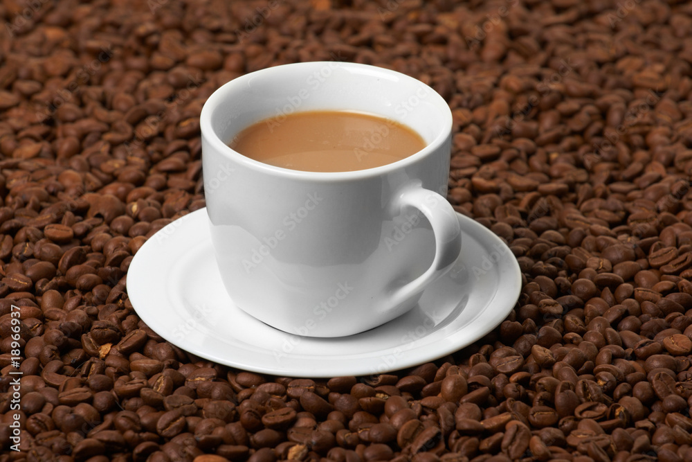 Cup with coffee, costing on coffee grain Cup with coffee, costing on coffee grain