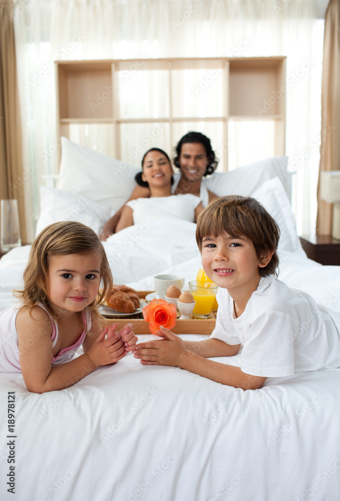 Siblings having breakfast with their parents Siblings having breakfast with their parents