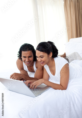Lauhing lovers surfing the internet