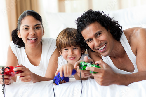 Boy and his parents playing video games
