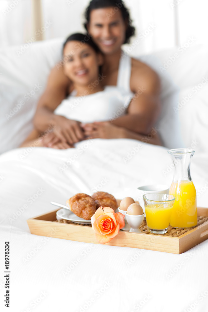 Couple having breakfast on the bed