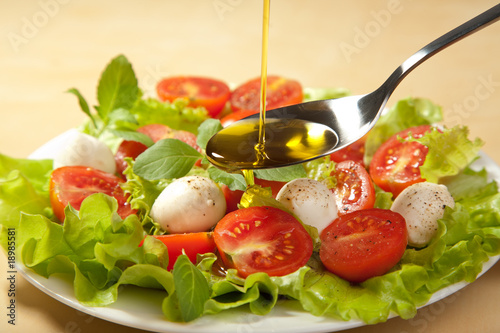olive oil pouring over salad