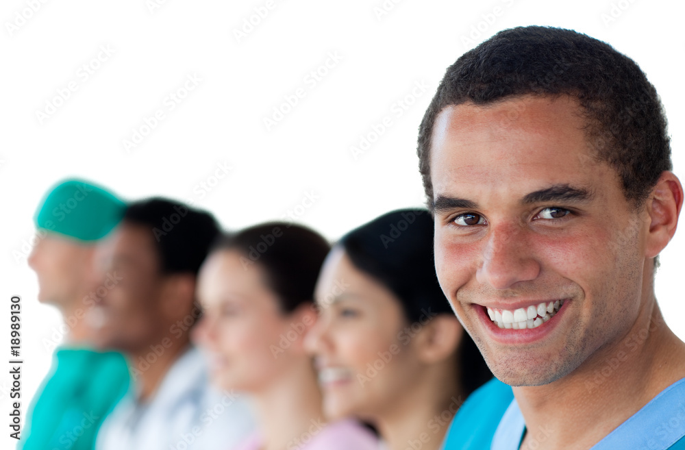 Attractive doctor with his colleagues in the background Attractive doctor with his colleagues in the background