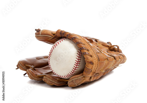 Baseball glove and ball on white