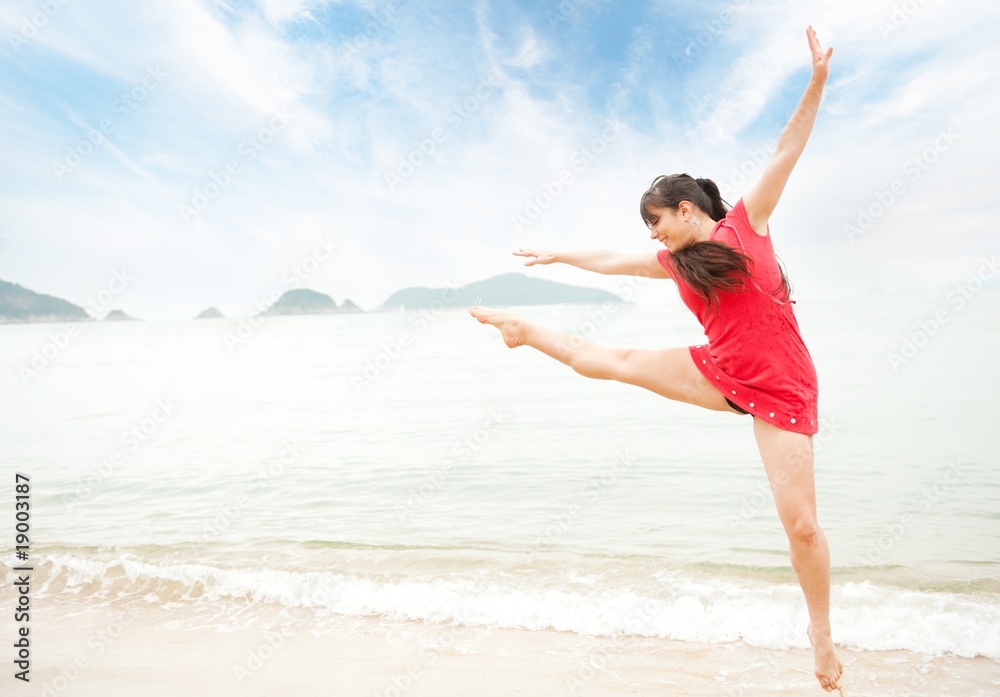 Beautiful young woman jumping in the sea . Beautiful young woman jumping in the sea .