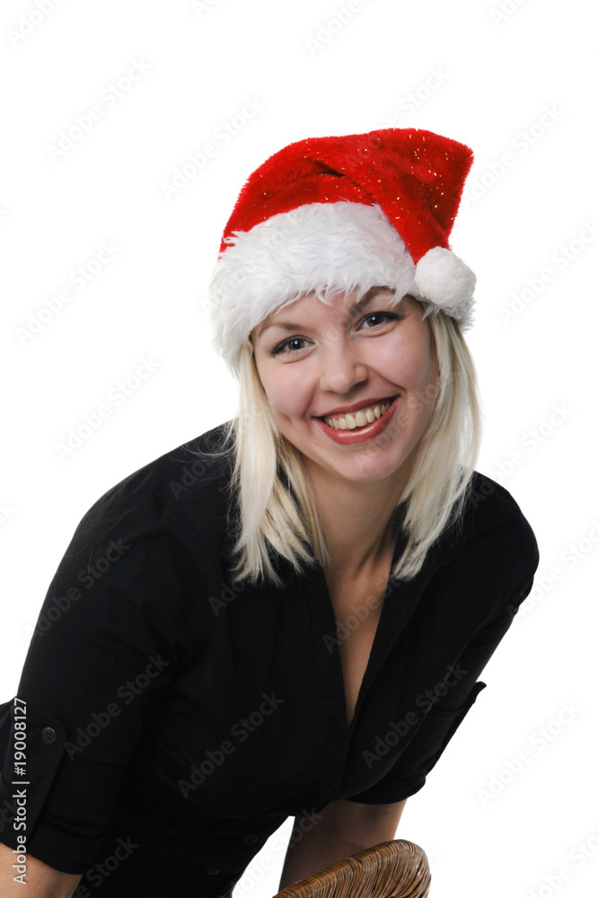 Young girl in a Santa Claus hat on the white background