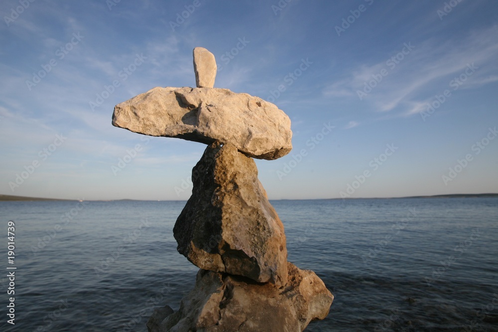 Cross, rocks stacked one one top of another on beach Cross, rocks stacked one one top of another on beach