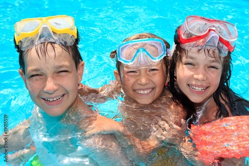 Three happy children in pool © Marzanna Syncerz