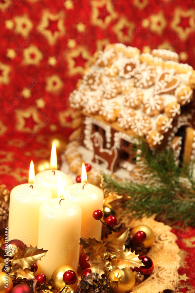 Christmas decoration with candles and gingerbread house