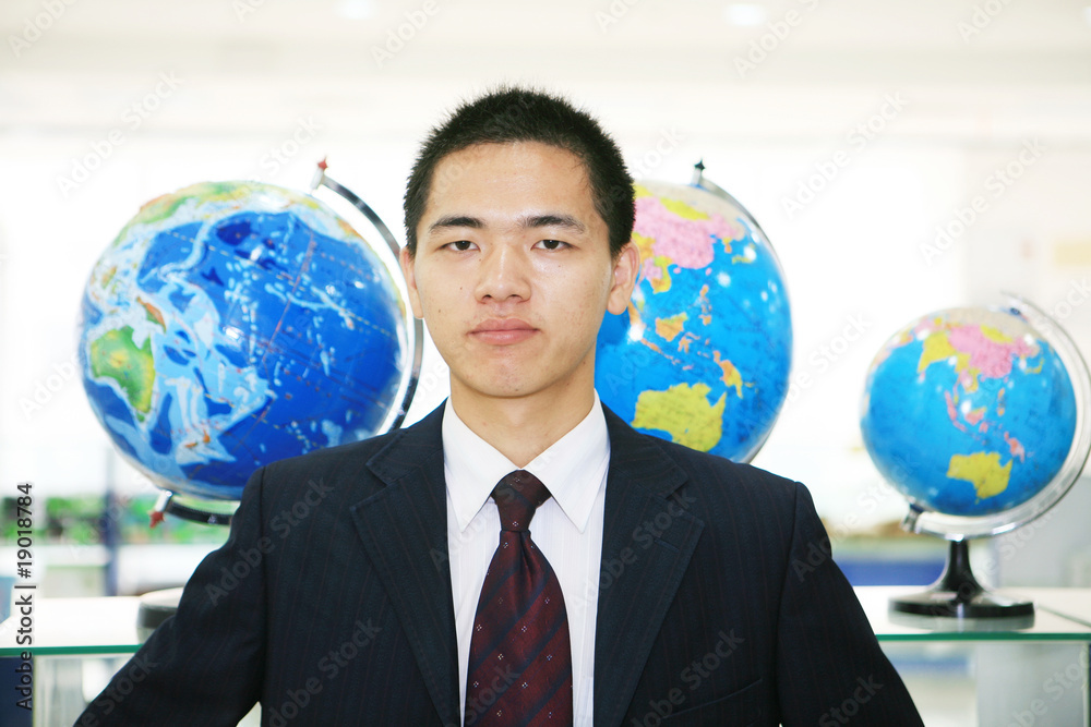 young asian businessman in the office with tellurion young asian businessman in the office with tellurion