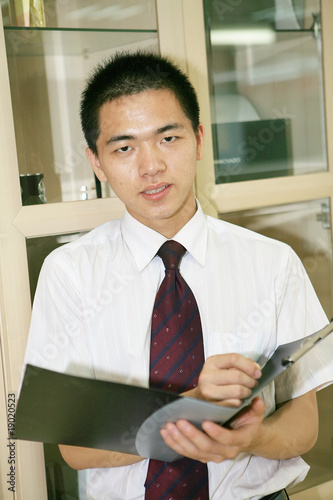 young asian businessman with folder photo