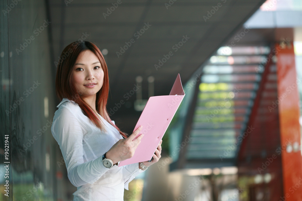 Beautiful Customer Representative holding with folder Beautiful Customer Representative holding with folder