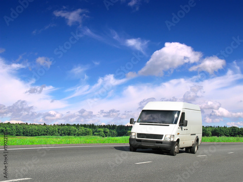 white van on country highway under blue sky © Antrey