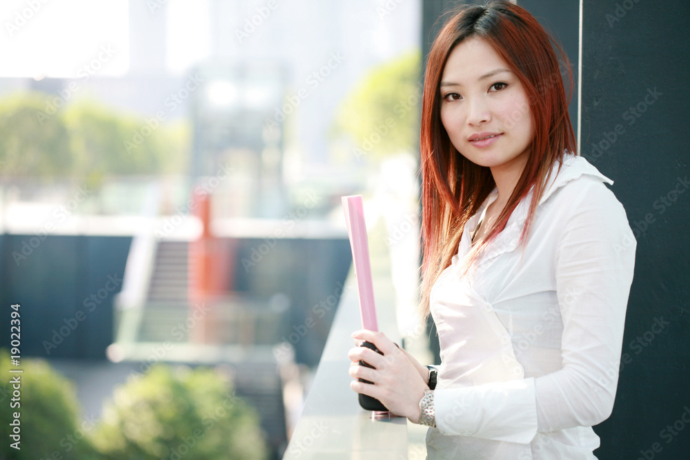 Beautiful Customer Representative holding with folder Beautiful Customer Representative holding with folder