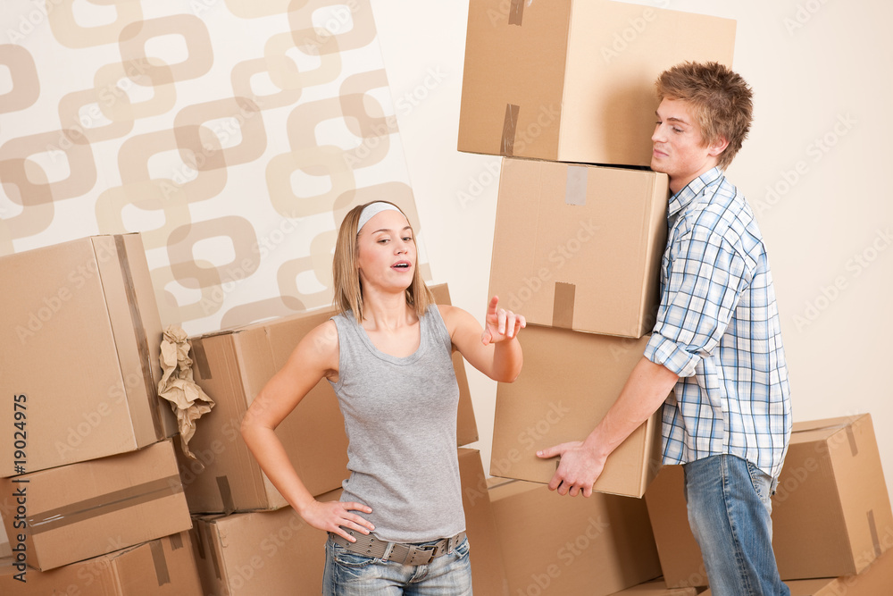 Moving house: Man and woman with box Moving house: Man and woman with box