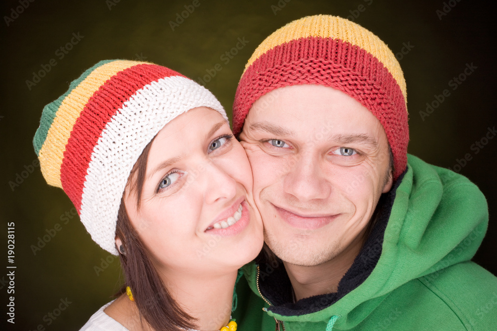 Positive pair in reggae hats smile together Positive pair in reggae hats smile together