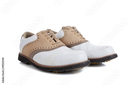 Pair of golf shoes on a white background