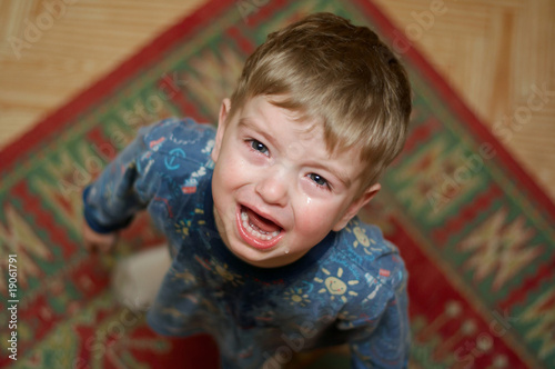 Crying little boy asks his mother's candy.