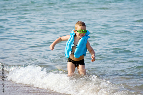 The boy on the beach. In anticipation of the surf