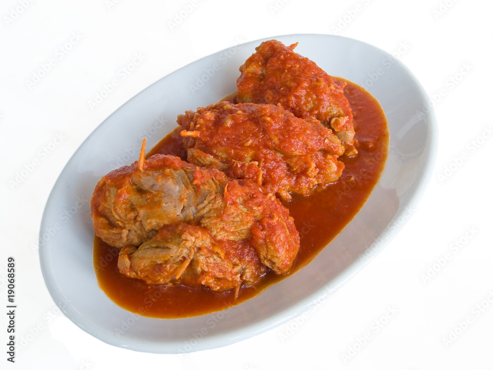 Meat roulade with tomato sauce on plate Meat roulade with tomato sauce on plate