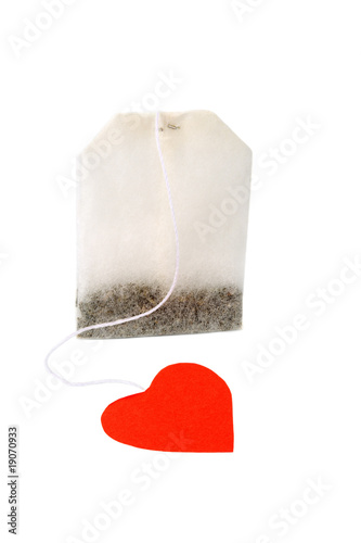 Tea bag with heart-shaped red label isolated