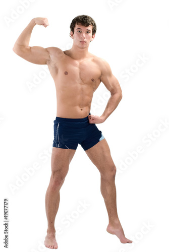 Young muscular man posing isolated on white