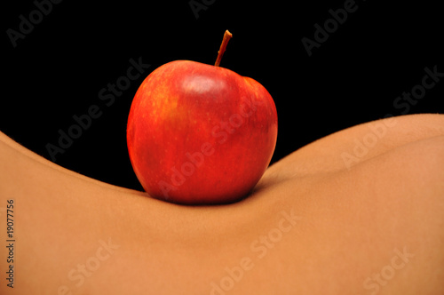 closeup of apple on woman`s back