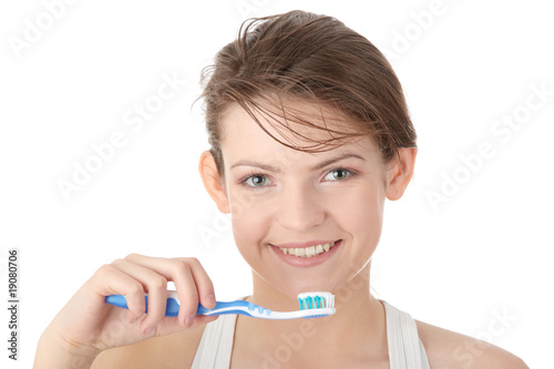 Young girl brushing her teeth happily