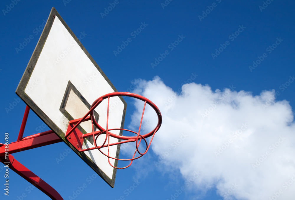 Park basketball ring close up and blue sky.