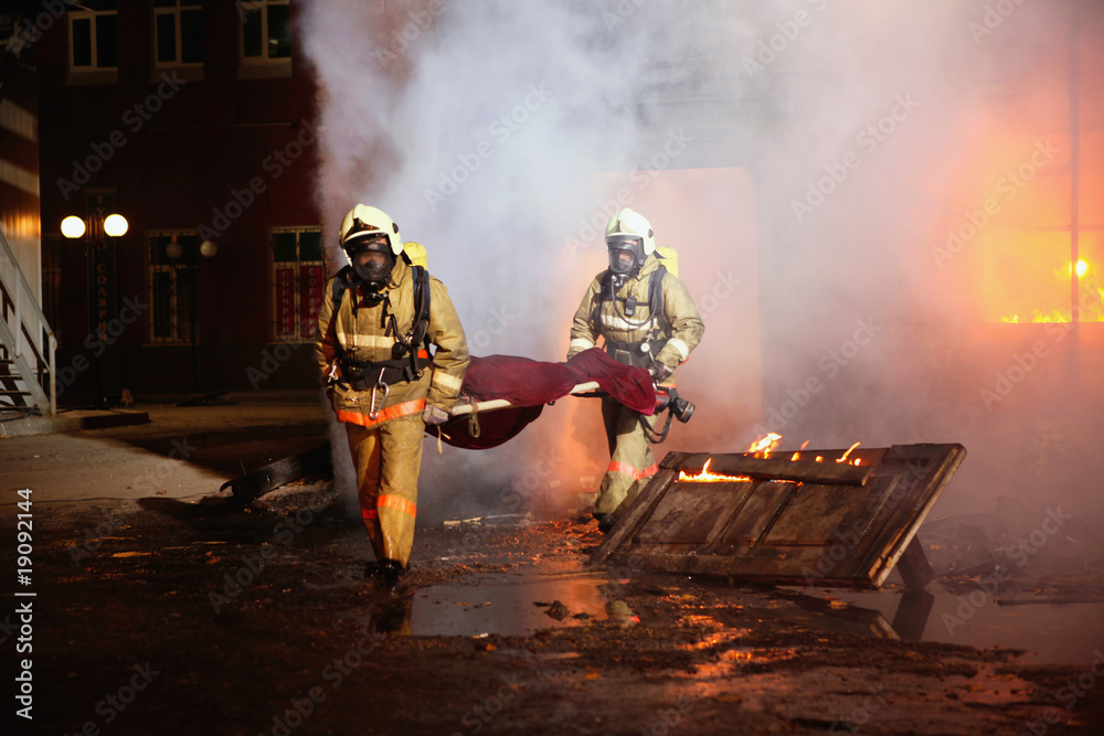 Fototapeta premium Firefighters carrying an accident victim