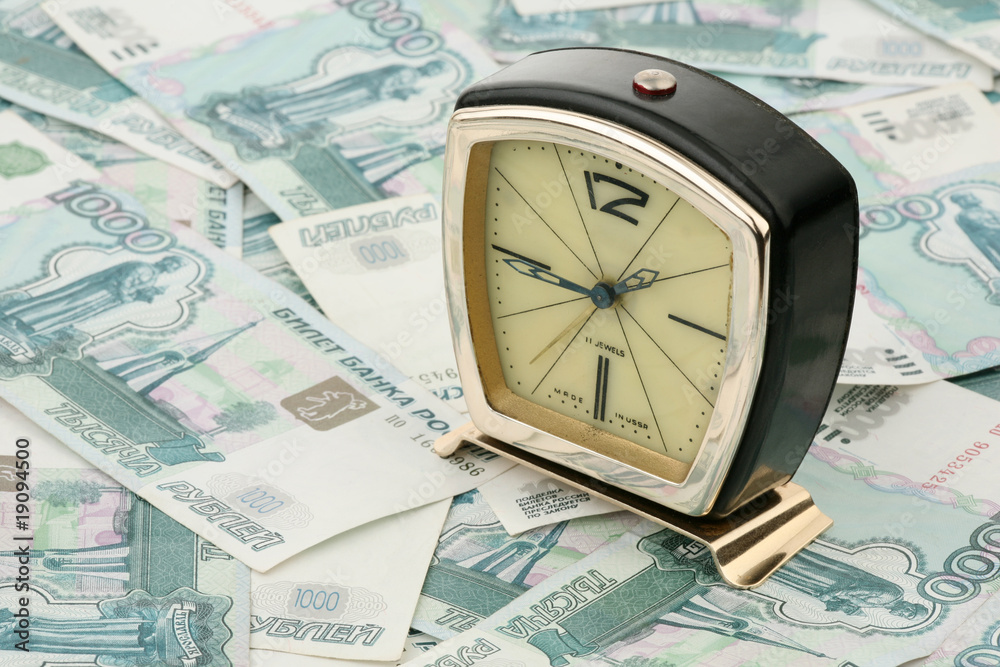 Old alarm clock against the Russian money Old alarm clock against the Russian money