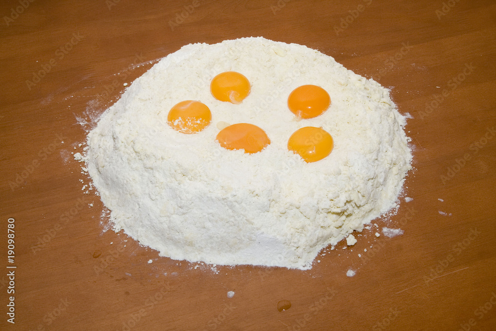 Flour and eggs on wooden table Flour and eggs on wooden table