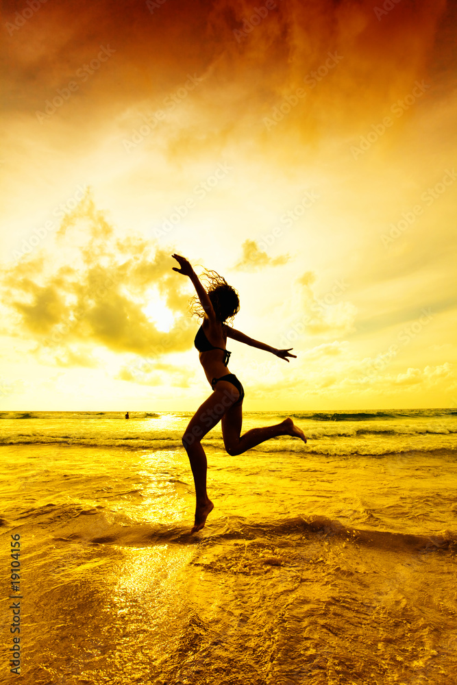 The jumping girl on a tropical beach