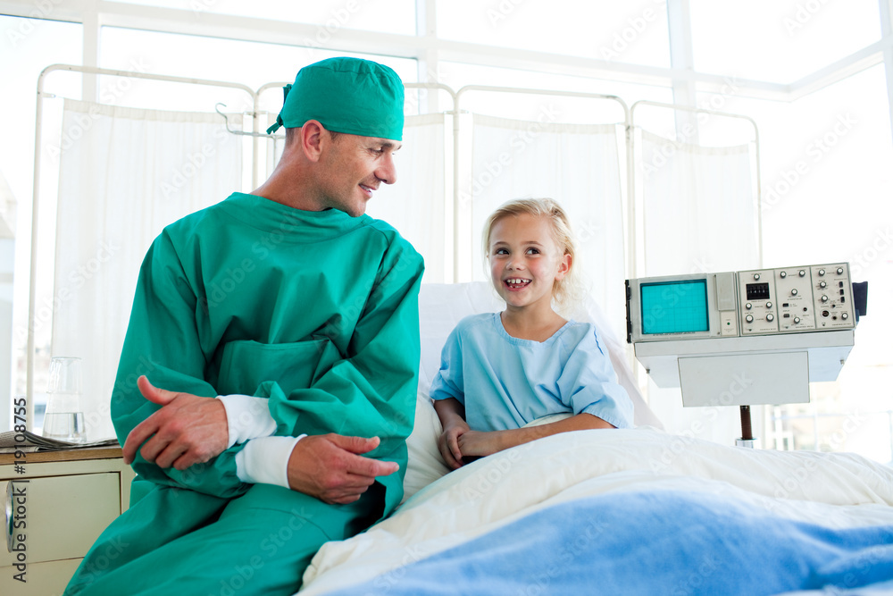 Attractive surgeon explaining a surgery to a child patient Attractive surgeon explaining a surgery to a child patient