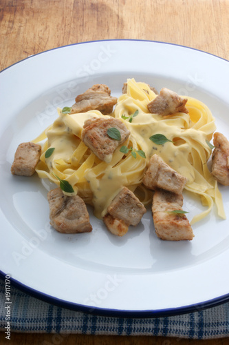 home made tagliatelle with organic chicken on a plate