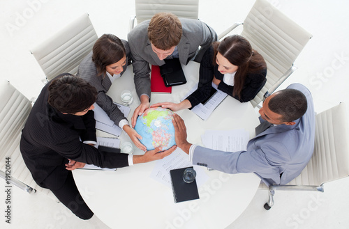 Internatonal Business team holding a terrestrial globe photo