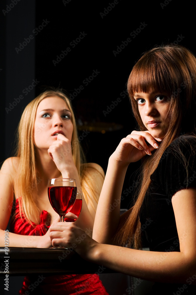 Two young women in a bar.