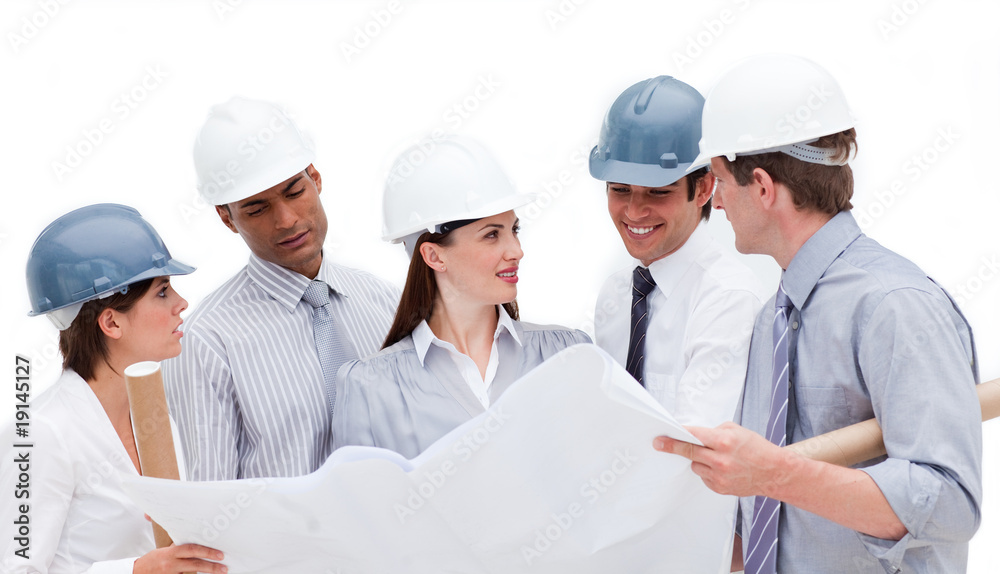 Multi-ethnic architects studying a blueprint Multi-ethnic architects studying a blueprint