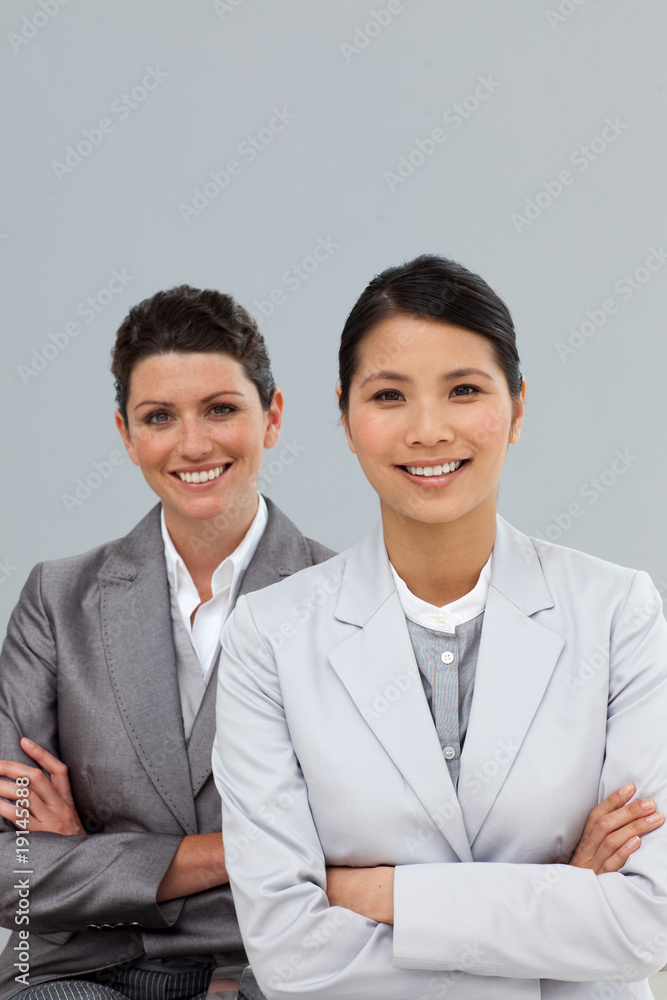 Confident businesswomen with folded arms standing Confident businesswomen with folded arms standing