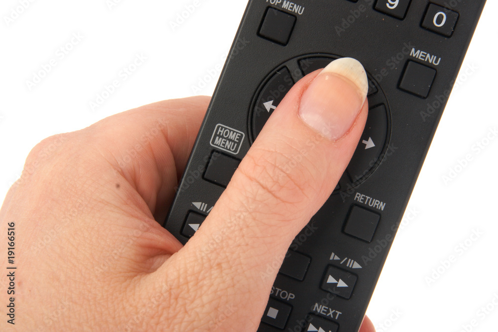 The finger of a hand pressing the button of a remote control The finger of a hand pressing the button of a remote control