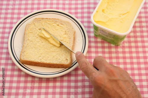 Buttering a slice of bread