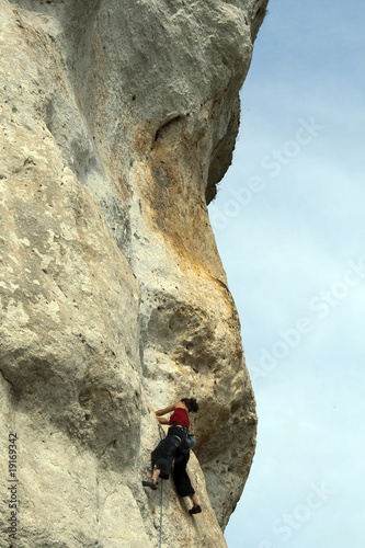 woman climbing on rocks