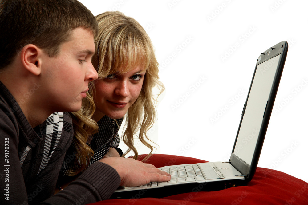 Two young people working on a laptop computer Two young people working on a laptop computer
