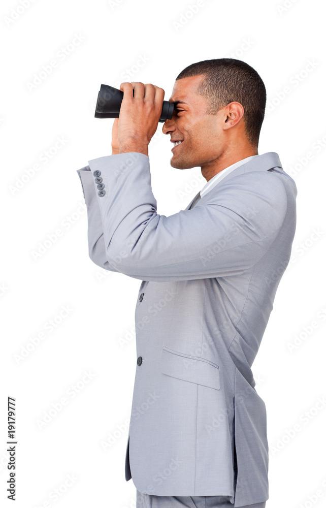 Smiling Attractive businessman looking through binoculars Smiling Attractive businessman looking through binoculars